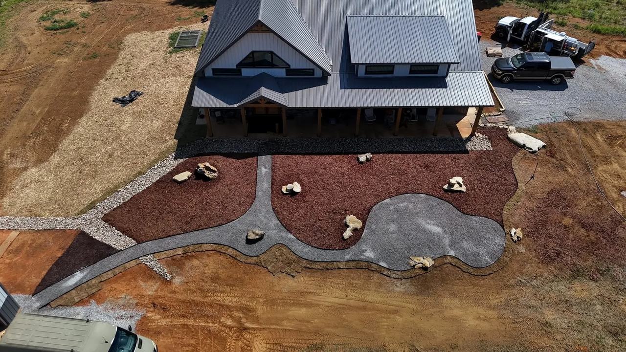 Aerial view of a rural property with defined aggregate paths, mulch zones and boulder placement