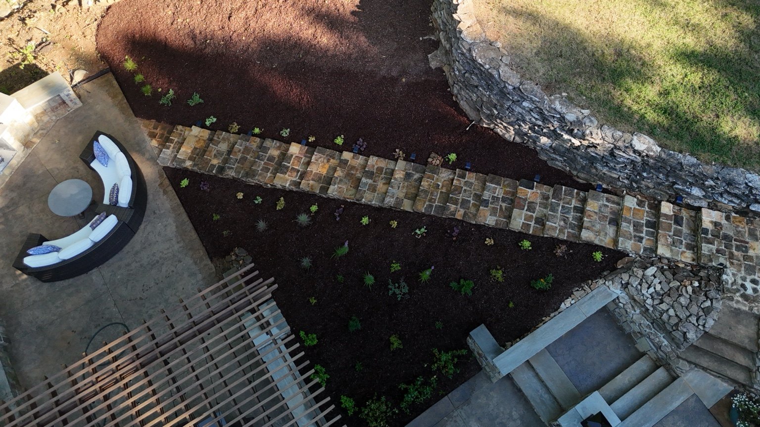 Aerial finished view of the outdoor living garden, stone path, seating and retained walls